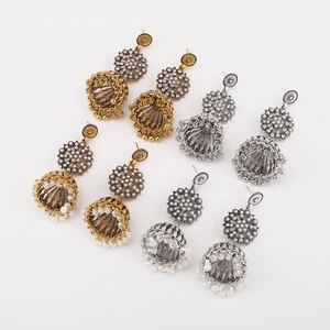 Detail view of four pairs of vintage bohemian jhumka bell earrings in gold and silver