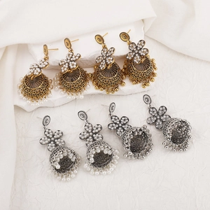 Detailed close-up of Bohemian Jhumka tassel earrings with crystal and pearl accents