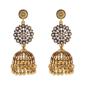 Detailed macro view of vintage golden bell Jhumka earrings with sparkling rhinestones