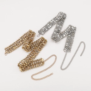Detail of double-layer metal waist chains in gold and silver with adjustable lobster clasp