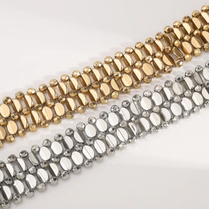 Detailed view of wide metallic beaded waist chains in shiny gold and silver finishes