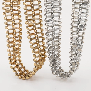 Close-up of golden and silver faceted bead chains with intricate woven details