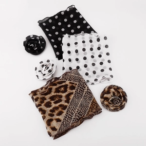 Detailed view of lightweight chiffon scarves with leopard, snake, and polka dot patterns
