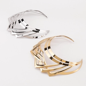 Detail view of gold and silver multi-layer geometric V-shaped chevron metal chokers