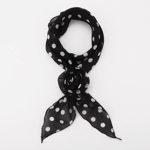 Close-up of lightweight black polka dot scarf featuring a 3D fabric rose decoration