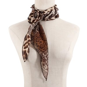 Detail of animal print long scarf tied in a flower knot on a mannequin neck