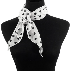 Close-up of elegant black and white polka dot silk scarf tied as a floral decorative knot