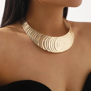 Macro shot of gold bohemian multi-layer choker necklace with intricate relief patterns