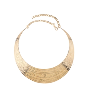 Macro shot of gold-plated choker featuring geometric tribal patterns and adjustable clasp