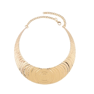 Close-up of gold textured metal choker necklace with intricate stamped patterns and clasp