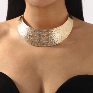 Golden wide metal choker necklace featuring ethnic geometric engravings and bohemian style
