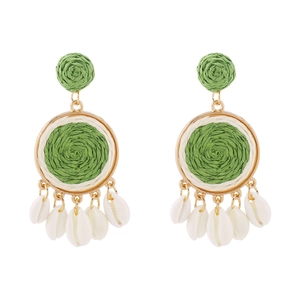 Detail of colorful raffia earrings with green woven balls and natural white shells