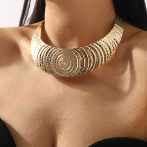 Ethnic style wide golden choker with textured concentric circles and detailed carvings