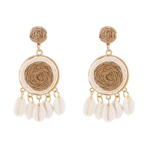 Detailed view of bohemian raffia woven earrings with natural shell pendants for summer