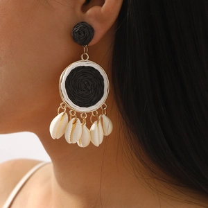 Bohemian woven raffia drop earrings with golden frames and natural white sea shells