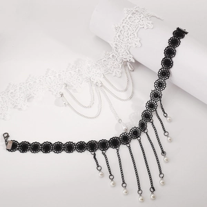 Detail showing black and white gothic lace chokers with faux pearl fringe and metal chains