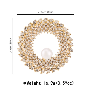 Detailed view of luxury wreath brooch with sparkling crystals and center pearl