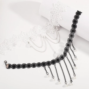 Detail of gothic lace chokers with metallic tassels and pearls in black and white