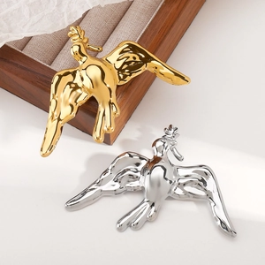 Vintage style metal flying bird brooches in gold and silver with fluid metal texture