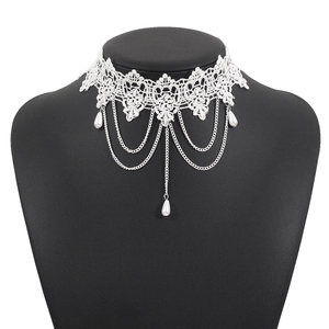 Detail view of white lace choker with silver chains and faux pearl pendants on a black model