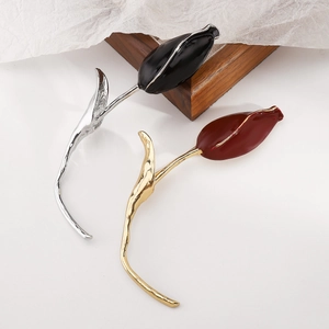 Detailed view of elegant tulip brooches with enamel petals and curved metallic stems
