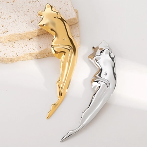 Polished stainless steel human torso brooches in gold and silver finish on stone