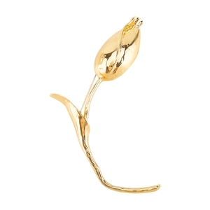 Detailed macro view of a golden tulip brooch with textured petals and elegant curved stem