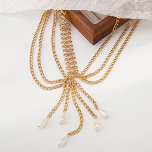 Detail showing multi-layer gold metal body chain with white teardrop pearl pendants