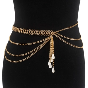 Detail of layered gold metal waist chain with elegant dangling water drop pearl charms