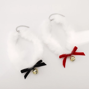 Détail de colliers en velours avec cloches dorées et fausse fourrure blanche