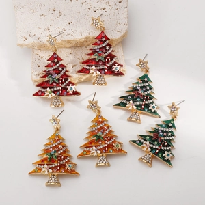 Detailed macro view of colorful enamel Christmas tree earrings with sparkling rhinestones