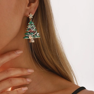 Festive Christmas tree earrings with green enamel and rhinestones on a female model