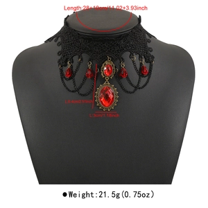 Close-up of gothic lace choker with red gemstone charms and size measurements