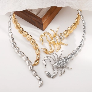 Macro shot of gold and silver scorpion choker necklaces with sparkling rhinestones