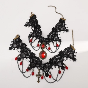 Detail of gothic lace chokers featuring red gemstones and cross pendants on white background