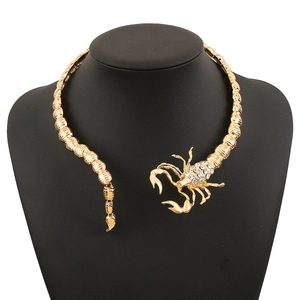 Detailed macro view of gold-tone alloy scorpion collar necklace with sparkling rhinestones