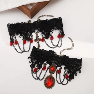 Macro shot of gothic lace chokers with vintage red gems and a bronze cross pendant