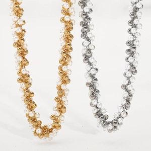 Close-up of pearl bead necklace in gold and silver finishes with a cluster design