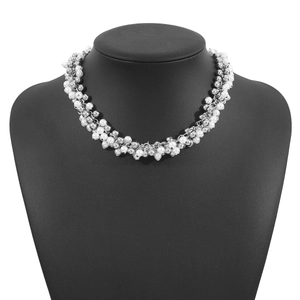 Macro view of cluster pearl necklace with white faux pearls and silver beads on bust