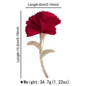 Detail of carnation brooch with red fabric petals and rhinestone-encrusted gold stem