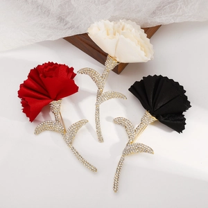 Detailed set of three fabric flower brooches in red, cream, and black with shiny rhinestones