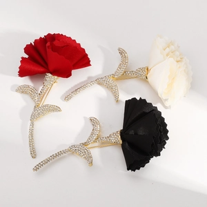 Detailed close-up of luxury fabric flower brooches with sparkling crystal rhinestones