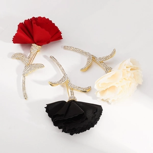 Detailed macro view of fabric flower brooches with sparkling rhinestone-encrusted gold base