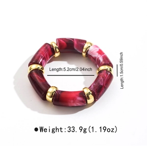 Close-up of marble resin bamboo stretch bracelet with polished gold spacers on white base