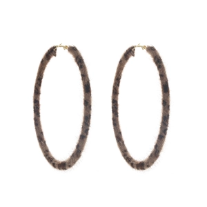 Detail view of large gold-tone hoop earrings with brown leopard print faux fur texture