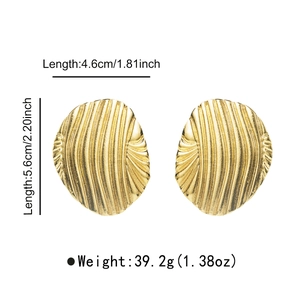 Detail view of large gold oval earrings with textured vertical ripples and dimensions