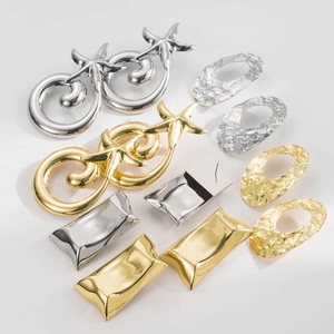 Detail shot of gold and silver irregular geometric earrings with starfish and hammered texture