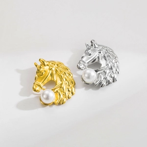 Detail of horse head brooches in gold and silver finish with large white pearls