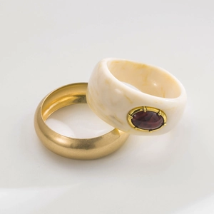 Vintage gold metal bangle and cream resin bracelet set with a deep red oval gemstone
