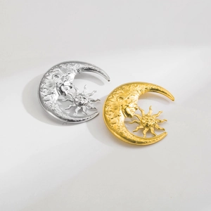 Detailed macro view of vintage sun and moon horsehead brooches in gold and silver plating